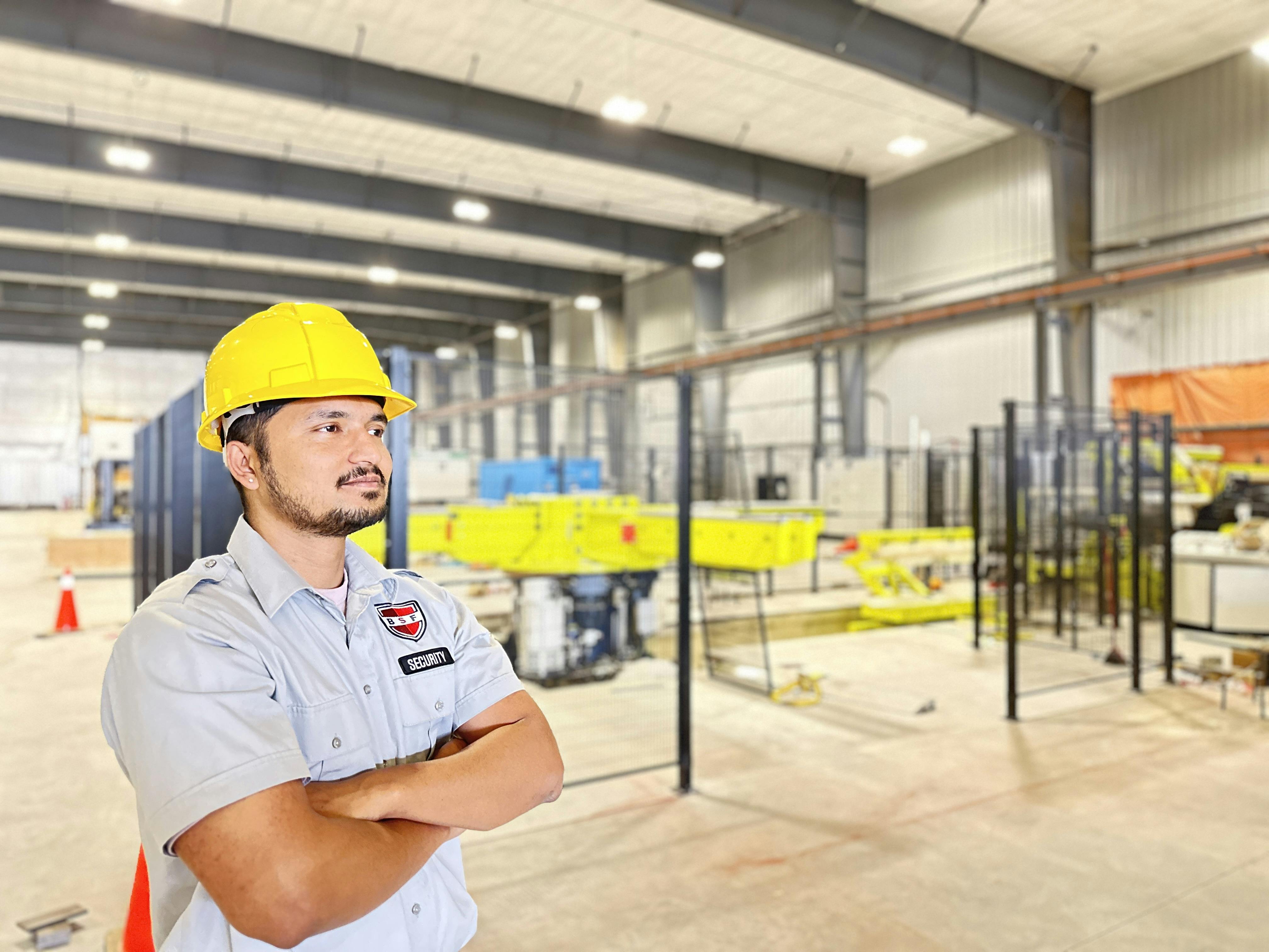 Security guard monitoring surveillance cameras