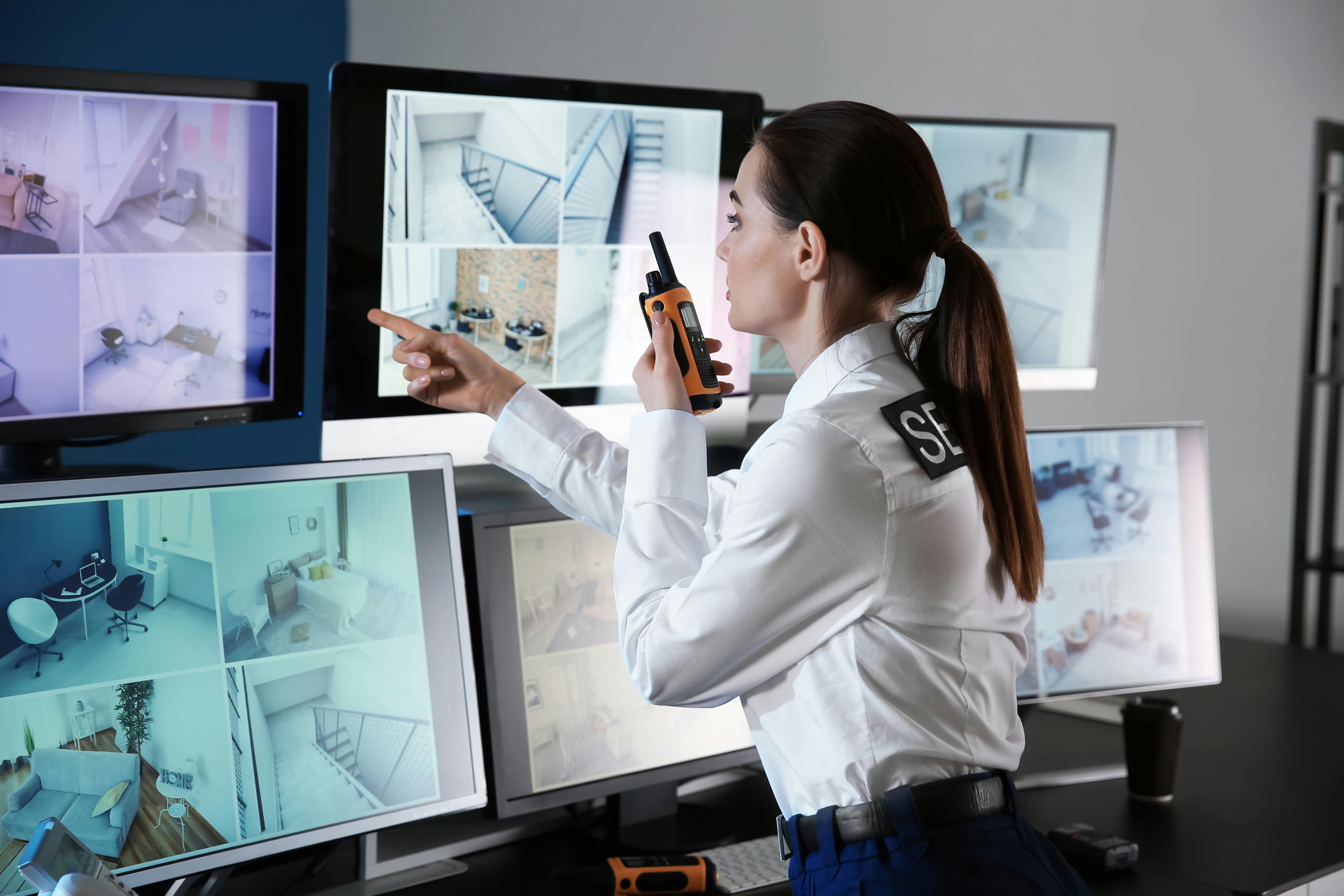 Security guard standing watch in front of a security control room